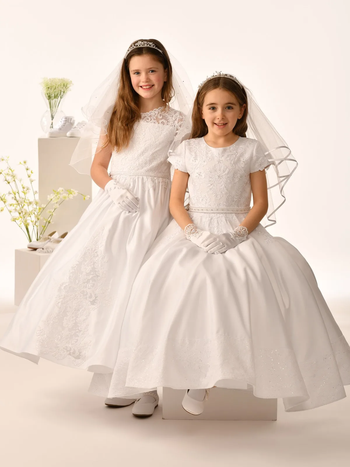 Two young girls in white dresses